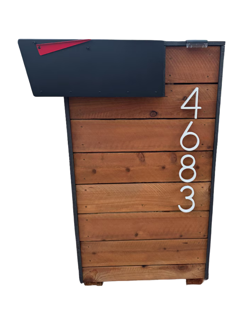 Wooden mailbox post with a black top and white address numbers on a white background