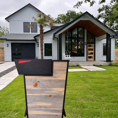 Modern house with a wooden mailbox post in the foreground