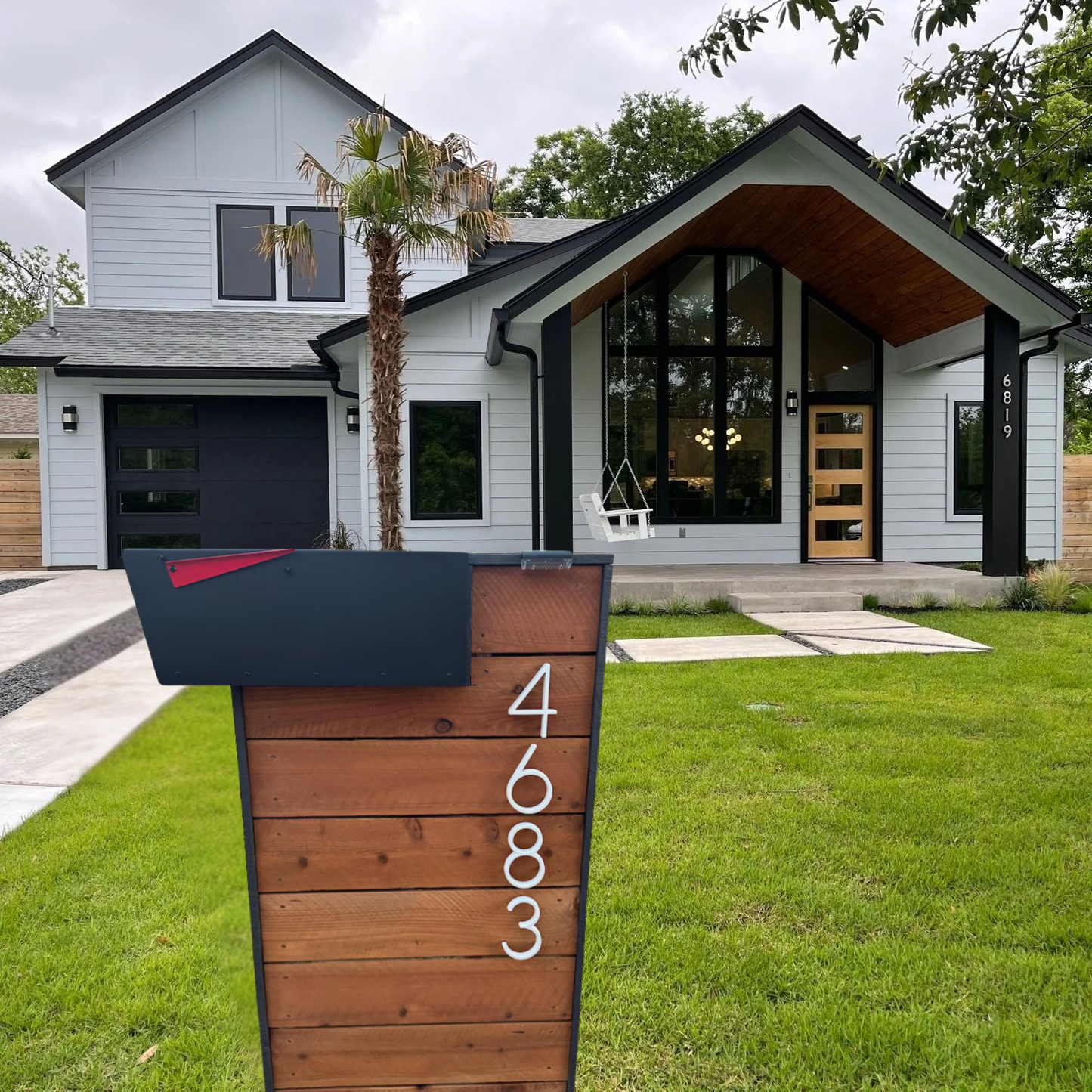 Modern house with a wooden mailbox post displaying the number 4683
