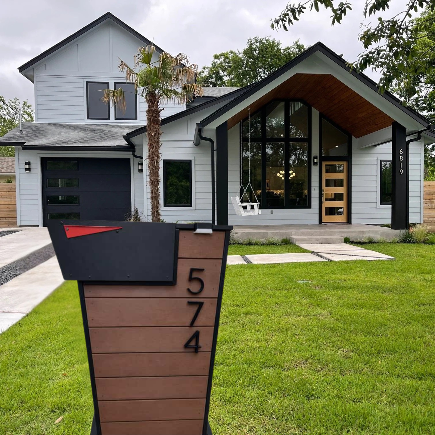 Modern house with a mailbox post in the foreground