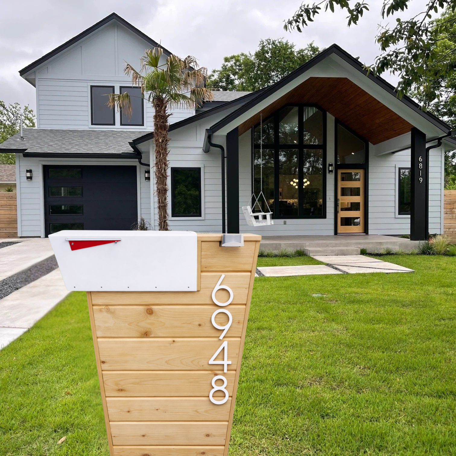 Modern house with a wooden mailbox post and address numbers in a suburban setting