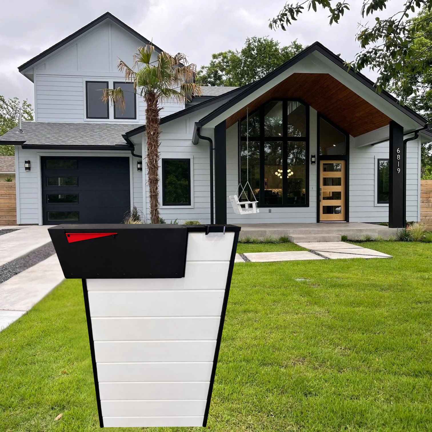 Modern house with a white mailbox post in the foreground