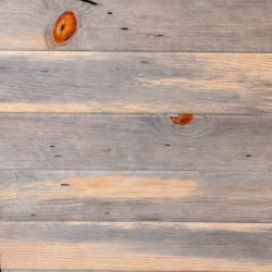 Close-up of a wooden surface with visible grain texture and blued pine finish